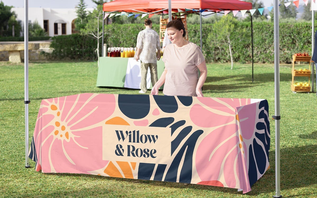 Custom printed tablecloth covering a trade show display table